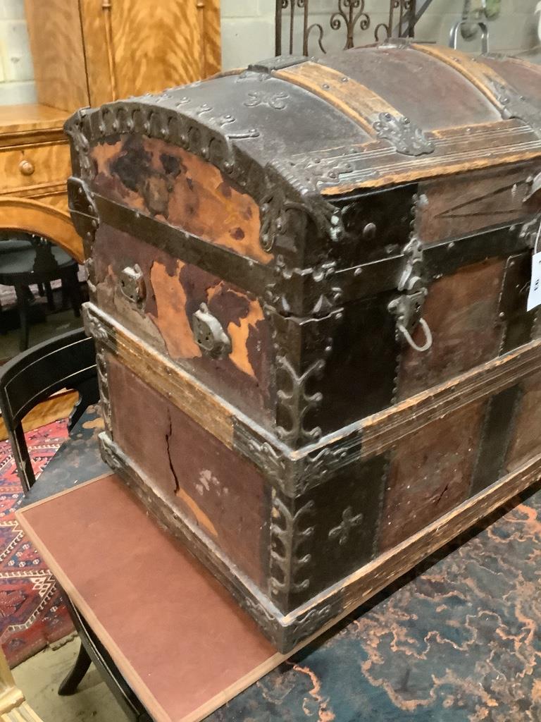 A late Victorian leather and metal mounted dome top trunk with scrap-work interior, length 76cm, depth 48cm, height 62cm
